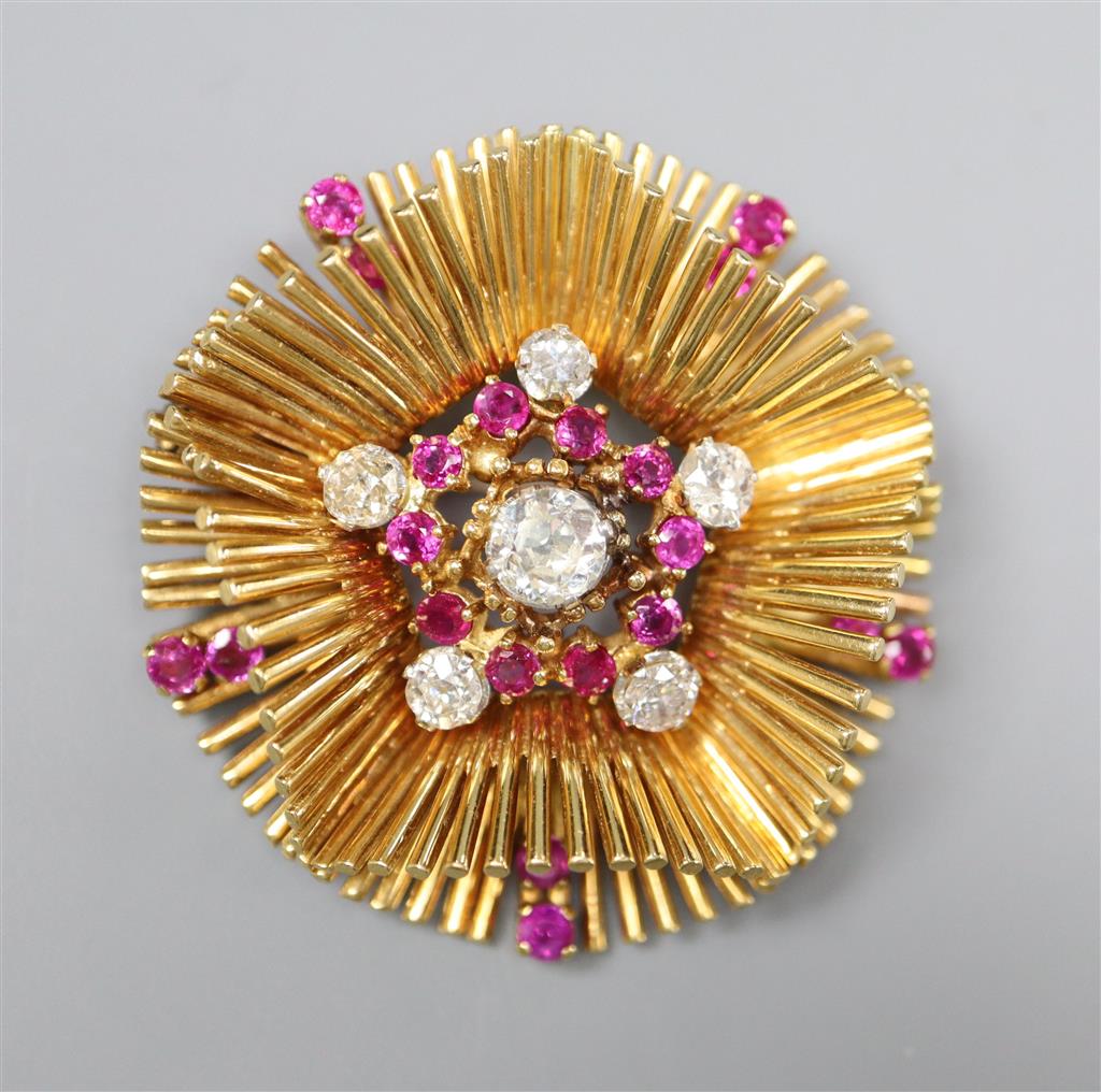 A late 1950s 18ct gold, ruby and diamond cluster set stylised flower head pendant brooch, 45mm, gross 39.3 grams.